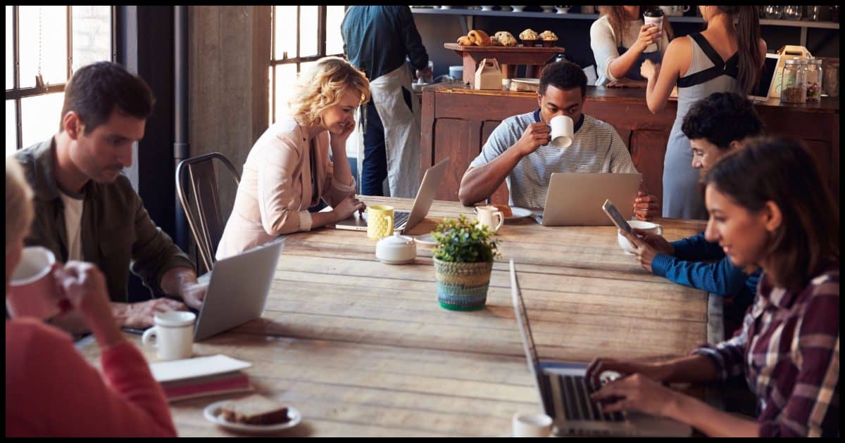 People in a coffee shop all using laptops and presumably Wi-Fi.